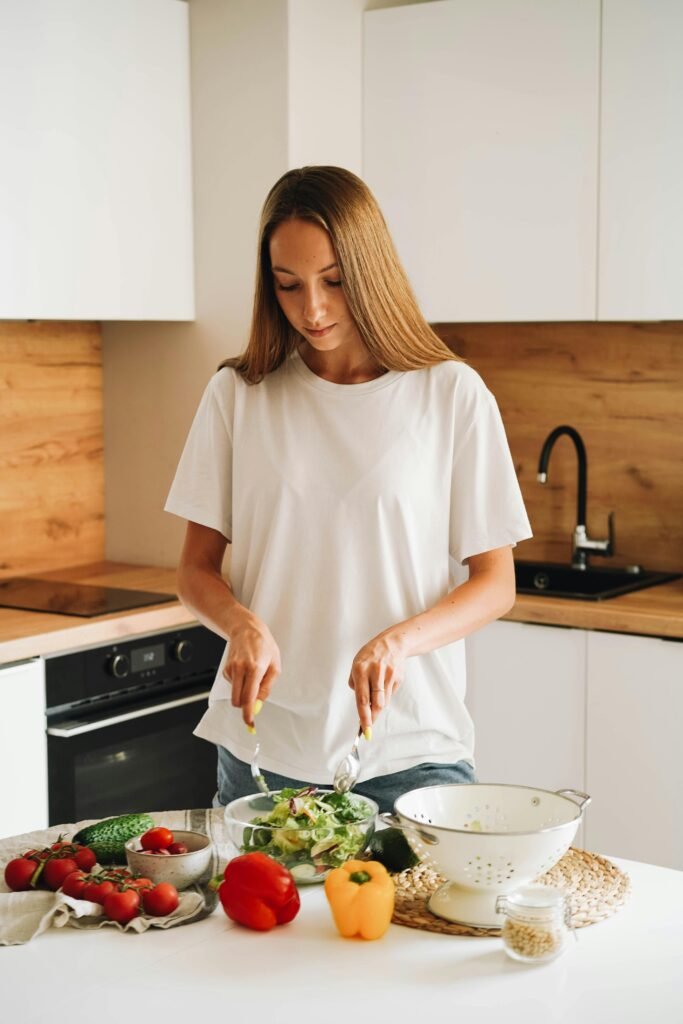 A women making a salad in a kitchen